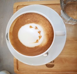 Hot Latte, this is the most popular drink coffee prepared with milk, sugar and milk foam in white cup.