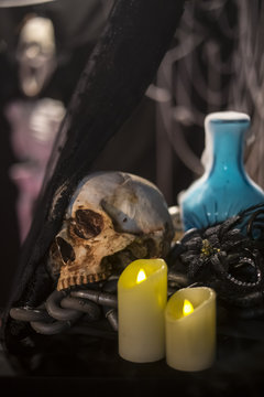 Halloween background with a lot of different witchcraft tools: scull, candles,and smoke