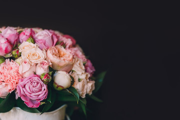 Flower arrangement of white and pink roses at the dark background. Wedding ceremony. Copy space