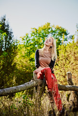 Woman sitting on fence