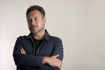 Adult Man in Blue Jacket with Arms Crossed Copy Space