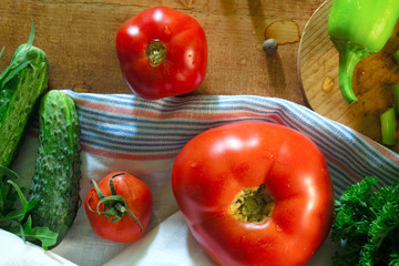 Tomatoes and cucumbers on wooden table