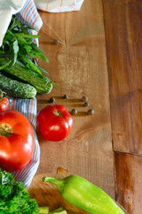 Tomatoes and cucumbers on wooden table