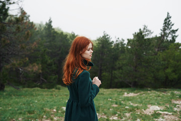 Beautiful young woman is walking in nature, in the forest, field