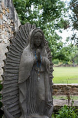 Statue of virgin mary with rosary beads
