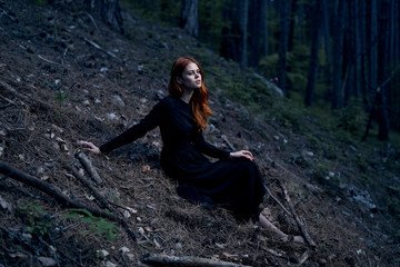 Young beautiful woman on nature in the mountains, forest