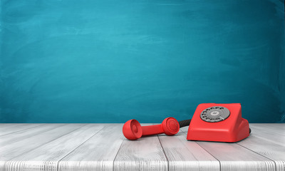 3d rendering of a bright red dial phone standing on a wooden desk and a blue wall background.