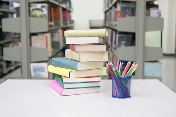 Image of Pile of books and stationery at library. Education concept.