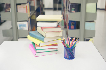 Image of Pile of books and stationery at library. Education concept.