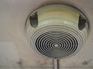 Old dirty round ceiling speaker grille in Thai local public bus