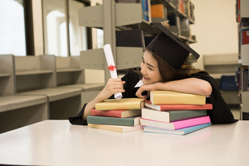 Happy graduate student holding a diploma in hand. Education concept.