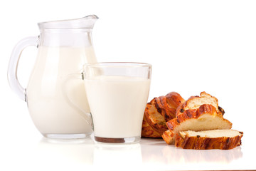 jug and glass of milk with a loaf of bread isolated on white background