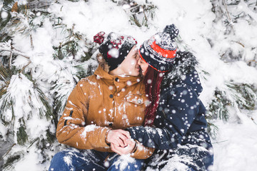 Сouple having fun and throwing snow in winter forest. A lot of snow around © Oleg Breslavtsev