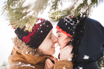 Close and emotional portrait of loving couple at winter with snowflakes. Nice sunshine weather © Oleg Breslavtsev
