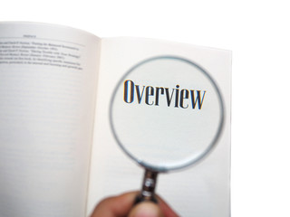 magnifying glass close up text OVERVIEW on book