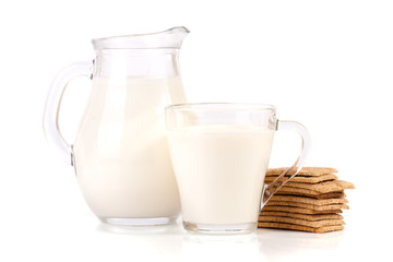jug and glass of milk with stack of grain crispbreads isolated on white background
