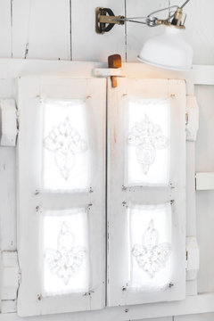 interior of light modern wooden house inside, vintage window with shutters and decorative curtains. Rustic and village style