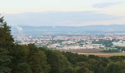 Ceske Budejovice in morning fog with city smoke and trees in left, Czech landscape