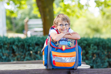 little kid boy with school satchel on first day to school - obrazy, fototapety, plakaty