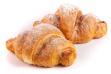 two croissant sprinkled with powdered sugar isolated on a white background closeup