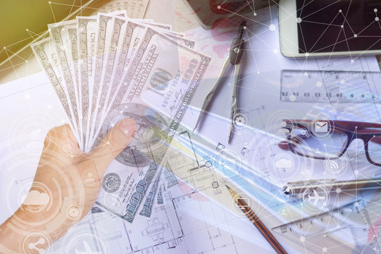 Double exposure of cash in hand and top view of engineer table , business and financial concept , selective focus.