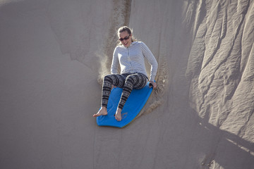 Thrill seeking woman Playing in the Sand Dunes Outdoor Lifestyle