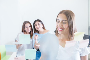 Woman and coworkers with paper documents