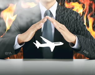 businessman and airplane with fire background, insurance concept