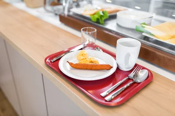 Schilderijen op glas Breakfast in hotel catering buffet, wooden desk and food in background  © stockcrafter