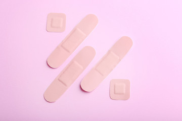 Medical plasters on pink background