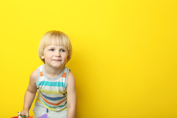 Naklejka premium Portrait of little boy on yellow background