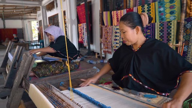Two indonesian women hand weaving traditional sarong in Sukarara Village, Lombok, Indonesia. Shot with Sony a7s and Atomos Ninja Flame.
