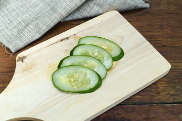 Cucumber slices on wood block