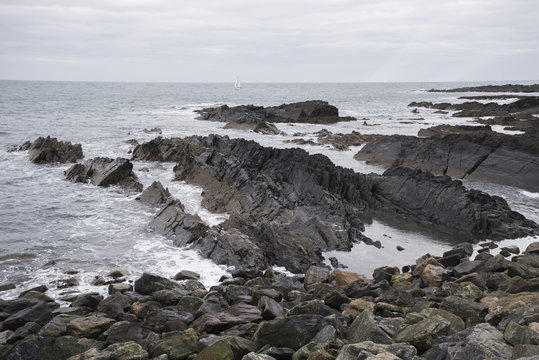 Yacht sailing in Banff Bay near MacDuff town coast in Scotland