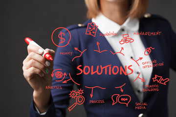 Business girl writes a red marker development strategy. The concept of marketing.Solutions