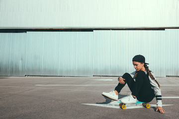 Pre teen skater on the city street © Alena Ozerova