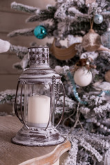 Obraz na płótnie Canvas Vintage lantern.home decoration with lighted christmas tree, presents. Christmas and New Year,home decor. christmas tree near fireplace. interior design, magic atmosphere. candles and present boxes