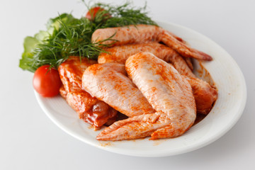 Raw marinade chicken wings with greens. Meat