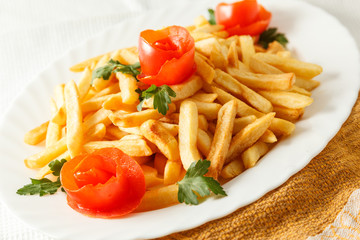 French fries potato on the plate with tomato