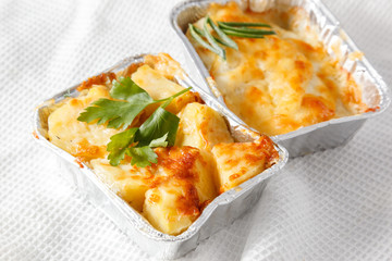 Potato gratin on the foil case box dish