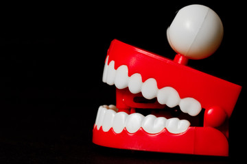 Chattering teeth toy from the side looking left mouth open
