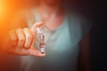 Businesswoman holding a lighbulb in her hand