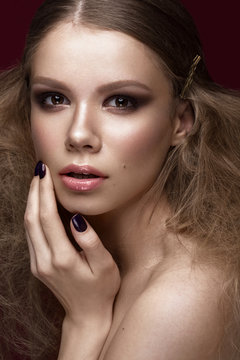 Beautiful girl with perfect skin, evening make-up, wedding hairstyle.Beauty face. Picture taken in the studio.