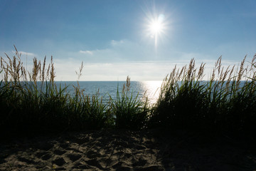 Beautiful beach landscape with sunset sky and soft waves over sand