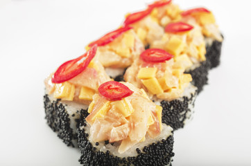 close up traditional japanese seafood sushi rolls with tobica eel and pepper on white background 
