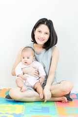 Portrait of happy asian mother hugging her cute baby