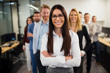 Obraz premium Business lady with positive look and cheerful smile posing for camera