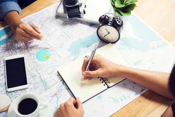 Writing note and consulting for traveling on map at office