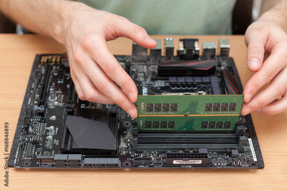Fototapete technician installing random access memory into pc