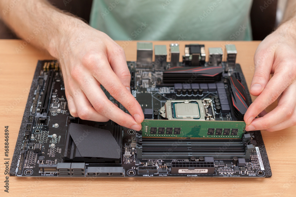Fototapete technician installing random access memory into pc
